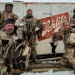 five men showing off their waterfowl hunt results