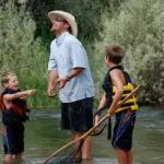 man fishing with kids on Bighorn