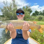 a woman holding a fish with two hands