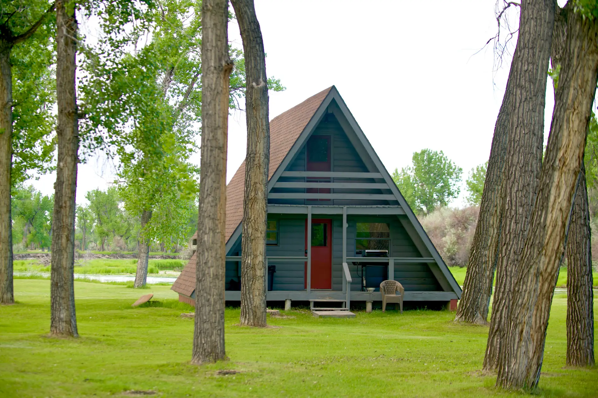 A frame cabin near a river