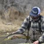 man holding fish with his right hand