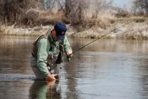 a man pulling a fish out of the water