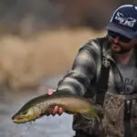 man holding a fish with his hand